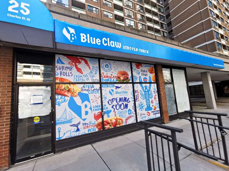 Blue Claw Lobster Shack storefront with a blue awning and window graphics